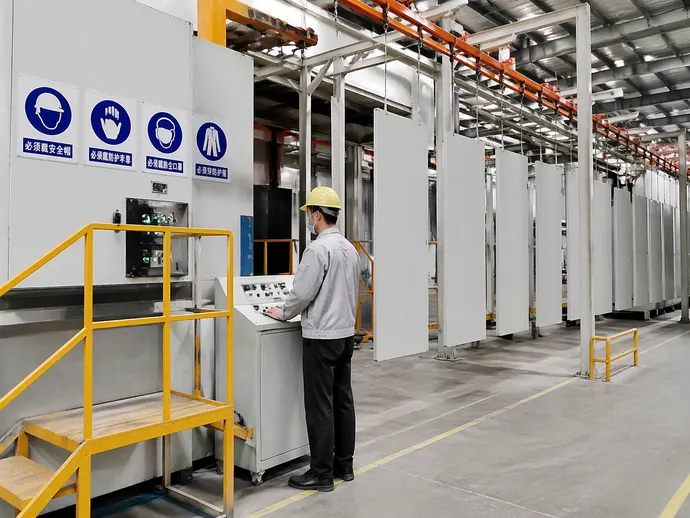 EUWOO factory floor showing powder coating line and worker safety equipment