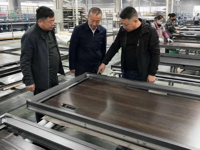 EUWOO production floor supervisors overseeing steel door manufacturing line